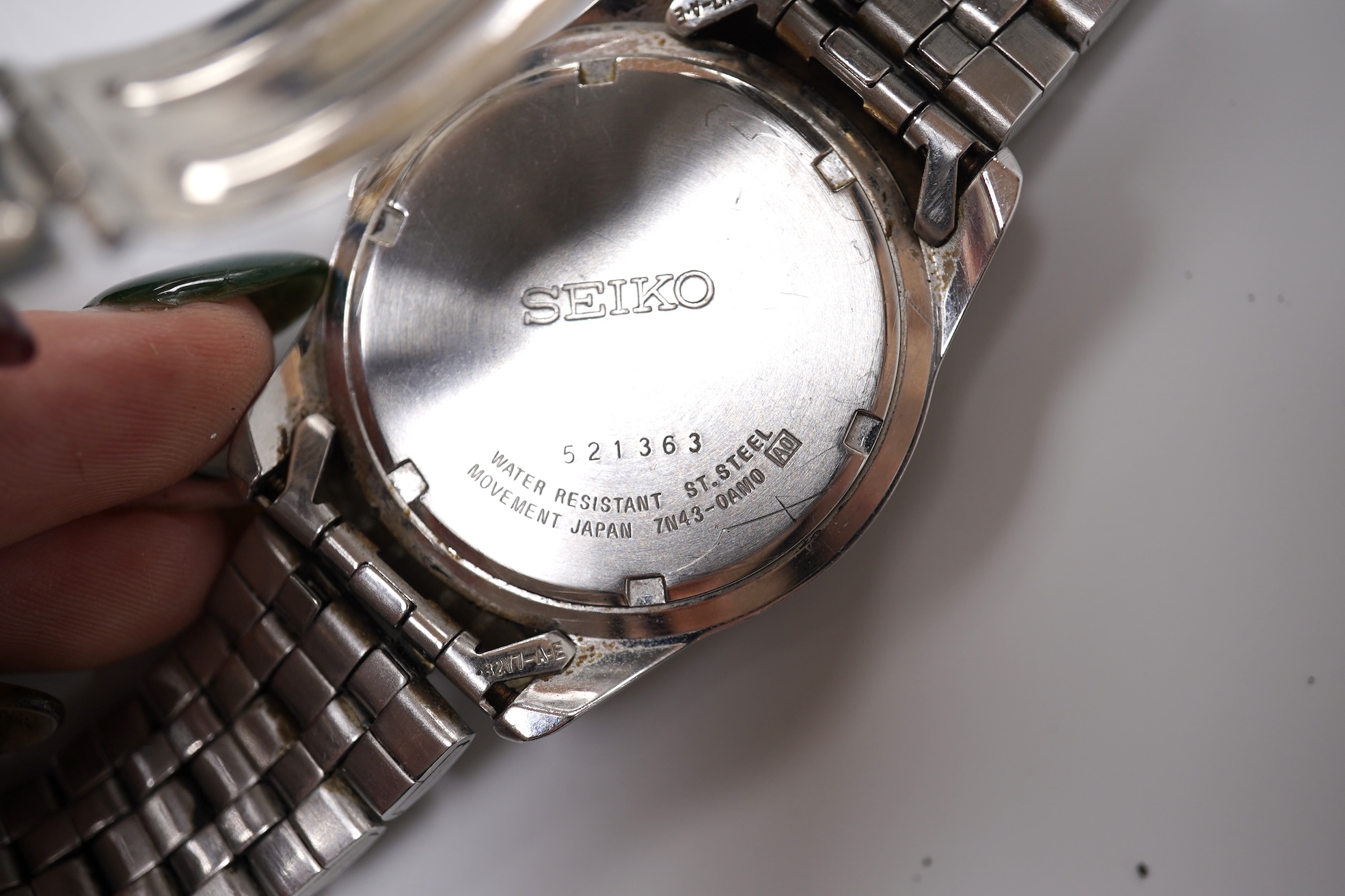 Four assorted gentleman's recent wrist watches including gilt stainless steel Rotary with visible escapement, Sekonda and Seiko.
